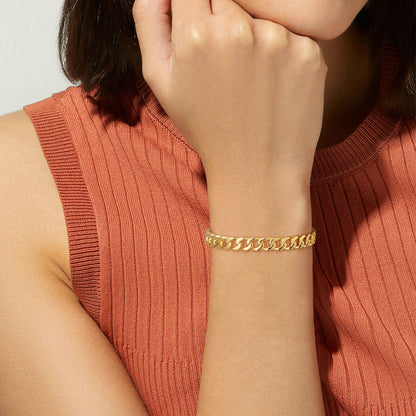 Woman's Wrist Adorned with 14K Gold Cuban Bracelet