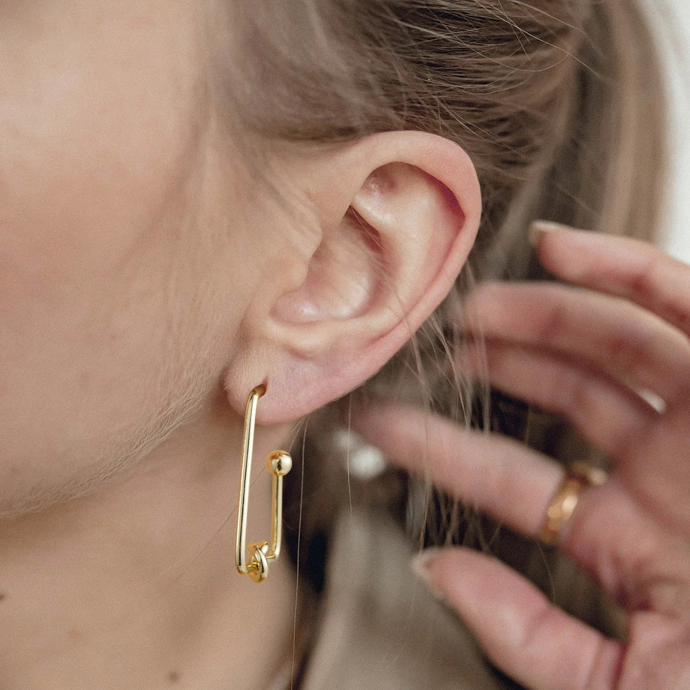 Close-up of Triangle Hoop in 14K Gold Geometric Twisted Huggie Hoops Earrings