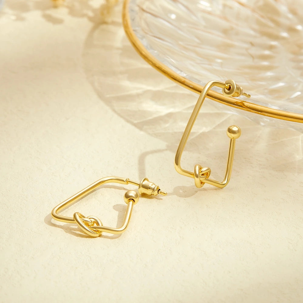 Detailed view of 14K Gold Twisted Huggie Hoops Earrings - Triangle Hoop