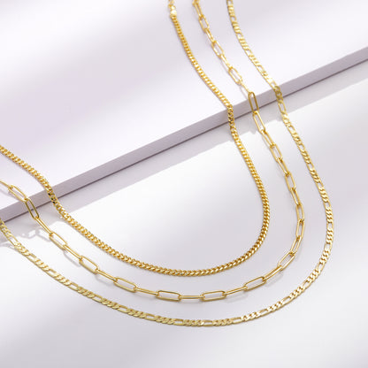 Close-up of 14K Gold Layered Necklaces - Cuban, Figaro, 4mm Paperclip